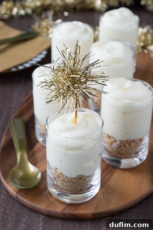 Make these fancy and easy white chocolate champagne cheesecake shooters for New Years Eve! I LOVE the gold tinsel toppers!