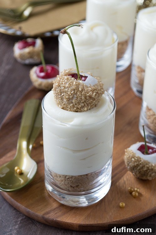 Make these fancy and easy white chocolate champagne cheesecake shooters for New Years Eve! I LOVE the cherries dipped in gold sprinkles! 