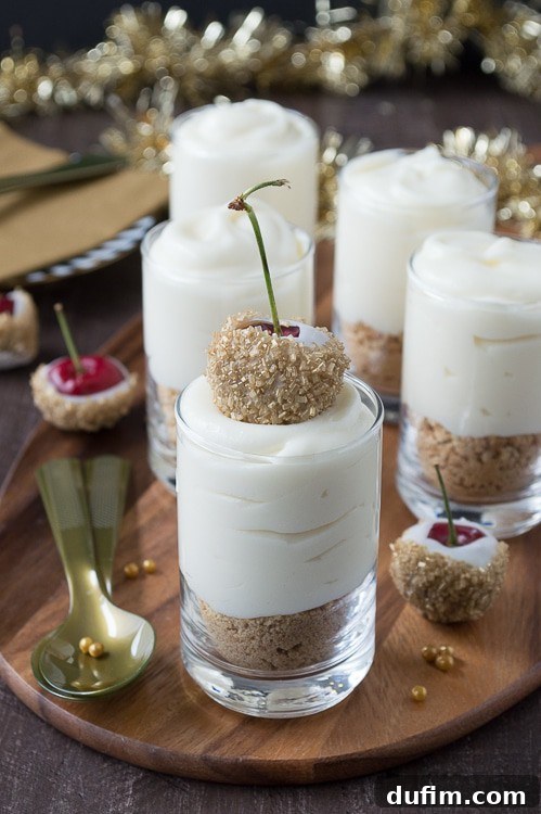 Make these fancy and easy white chocolate champagne cheesecake shooters for New Years Eve! I LOVE the cherries dipped in gold sprinkles! 