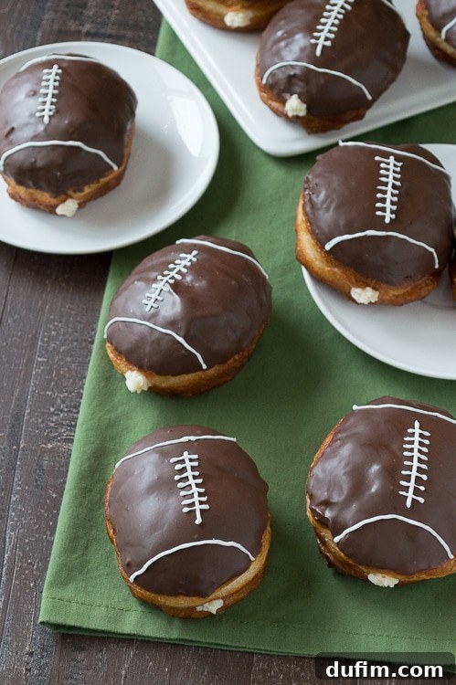 Delicious cream-filled chocolate football donuts arranged for game day