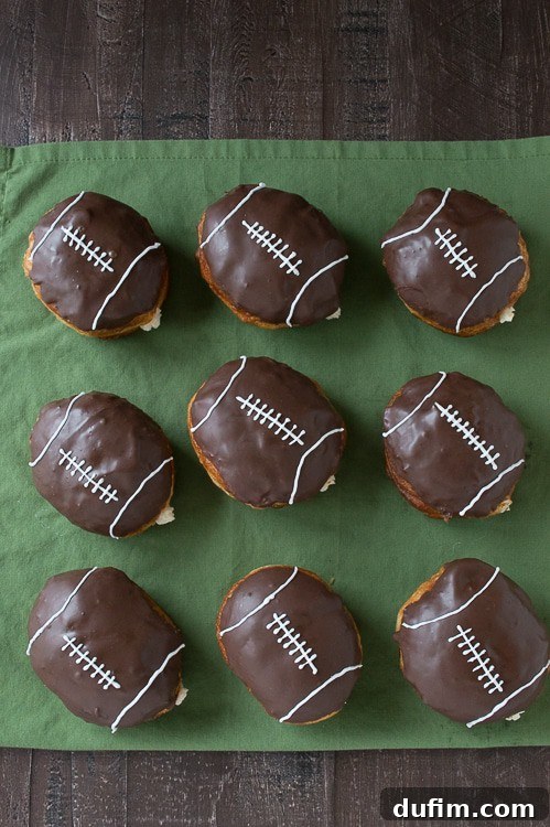 Pigskin Perfection Donuts 4 Several cream-filled football donuts arranged on a white serving tray