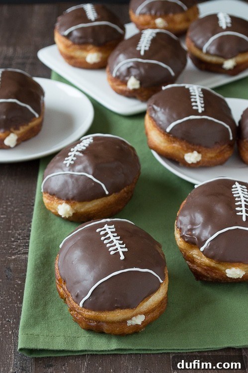 Pigskin Perfection Donuts 7 Finished cream-filled chocolate football donuts displayed on a wire rack