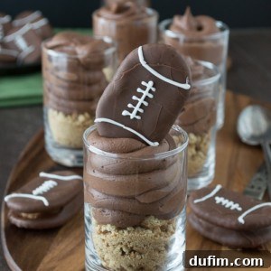 Delicious Chocolate Cheesecake Football Shooters topped with peanut butter footballs.
