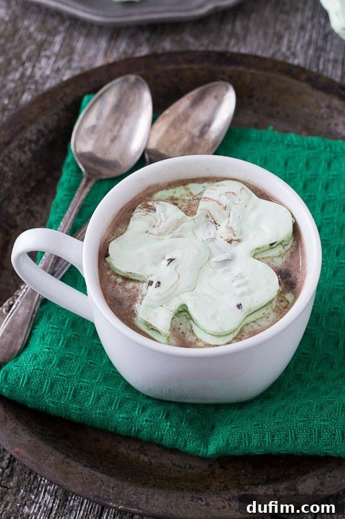 Mint Chocolate Chip Shamrock Marshmallows in a mug of hot cocoa.