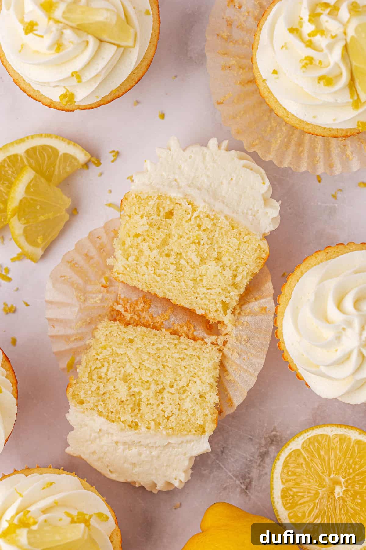 Ingredients for lemon cupcakes laid out on a marble counter