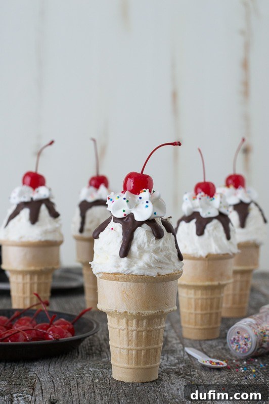 Ice Cream Cone Cupcakes with colorful sprinkles and a cherry on top, arranged on a rustic wooden surface.