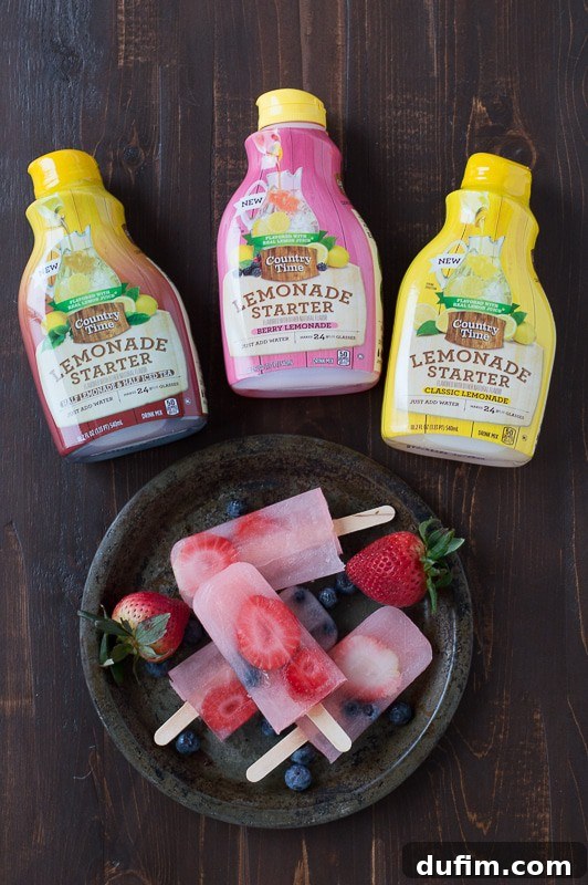 Zesty Berry Lemonade Pops 3 Two bottles of Country Time Lemonade Starters, one original lemonade and one berry lemonade, standing on a counter.