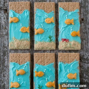 Six delicious and easy Under the Sea Graham Crackers on a wooden table.
