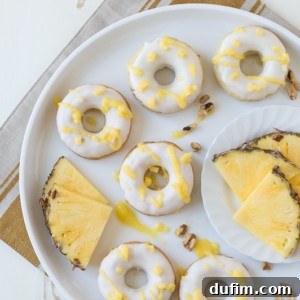 Pineapple Walnut Donuts with a white chocolate glaze and pineapple puree drizzle!