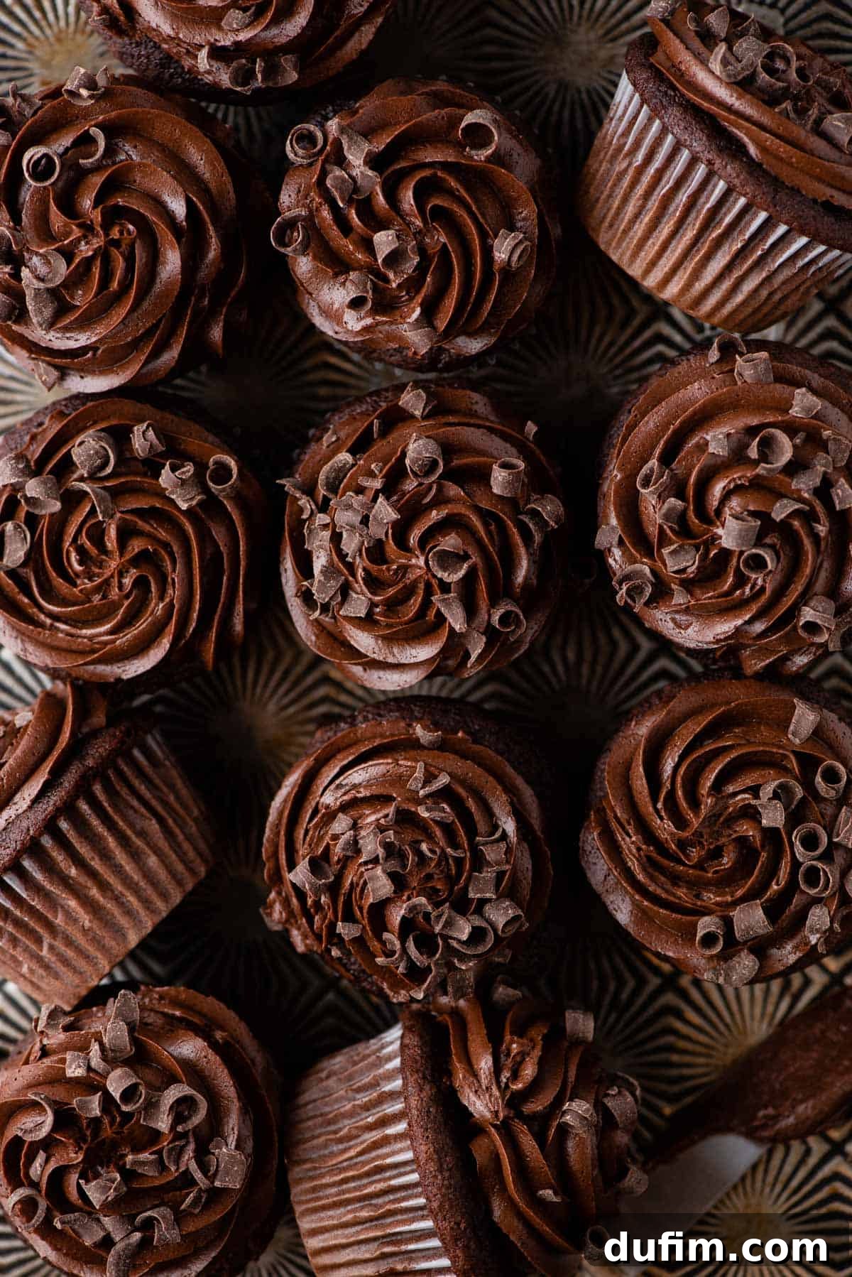 Decadent Chocolate Delights 6 aeriel shot of chocolate cupcakes with chocolate frosting arranged in a grid pattern on metal surface
