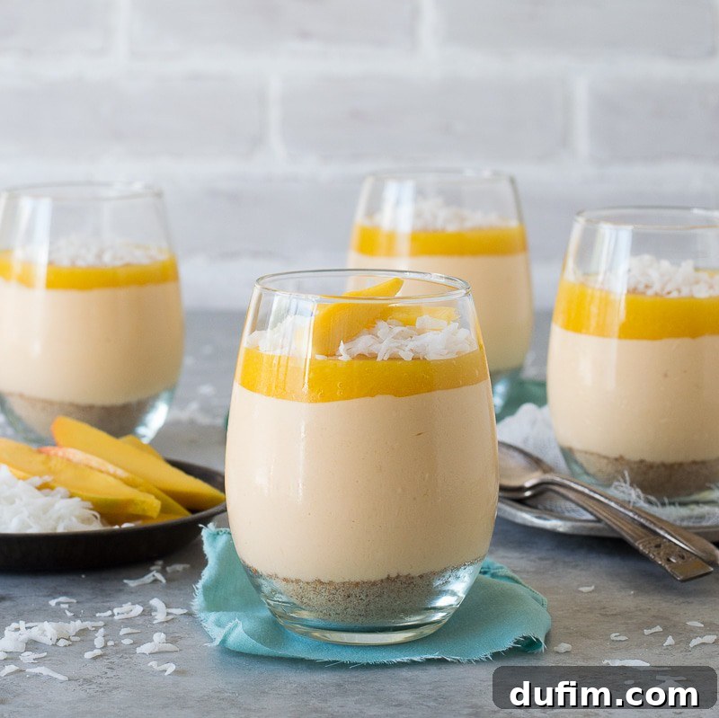 Lush mango coconut cheesecake jars layered with fresh mango puree, a perfect no-bake dessert for mindful enjoyment.