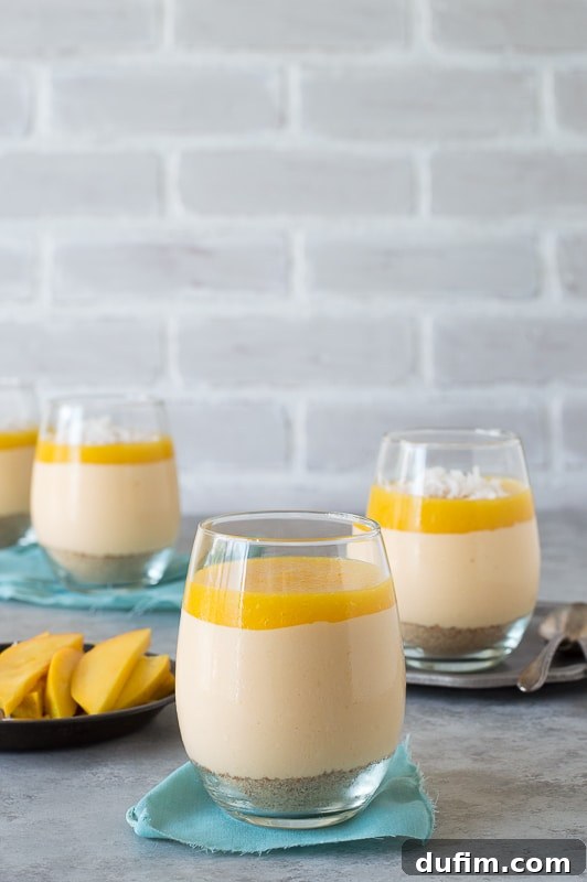 Close-up of a creamy mango coconut cheesecake jar, showcasing the vibrant layers of dessert, a delightful treat.