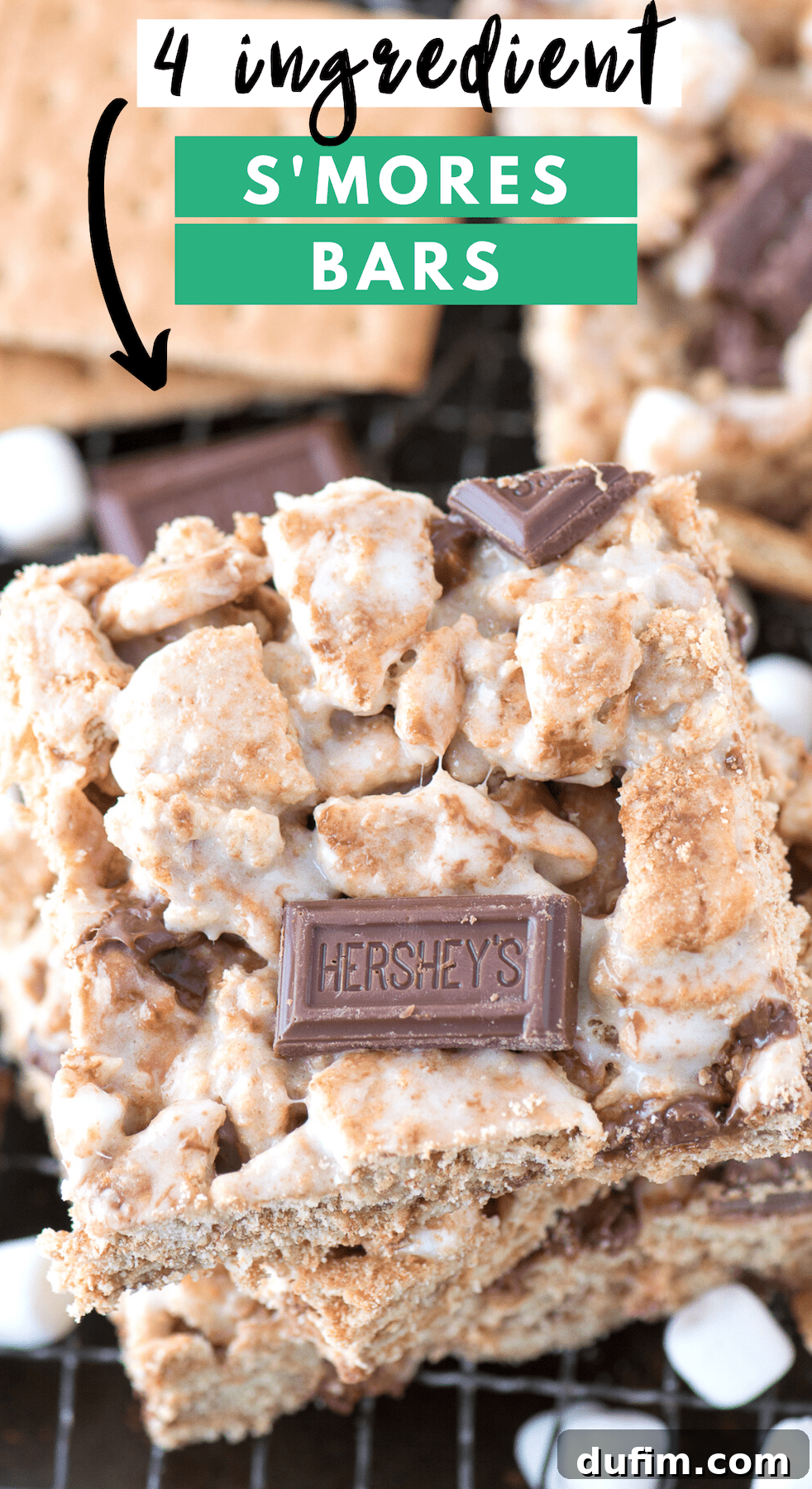 Close-up of freshly cut s'mores bars, showcasing gooey marshmallow, chocolate pieces, and graham cracker bits, with a Hershey's chocolate bar in the background.