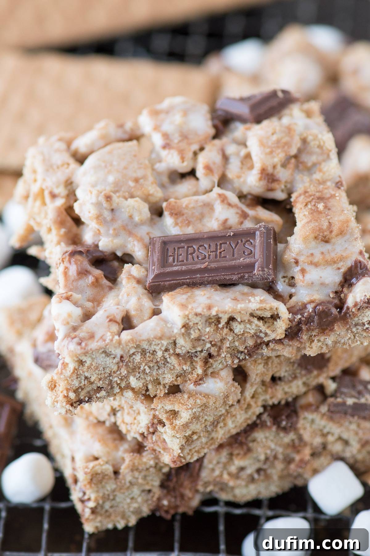 Gooey marshmallow, graham cracker, and chocolate S'mores bars on a platter, ready to be served. This is the ultimate s'mores treat without a campfire!