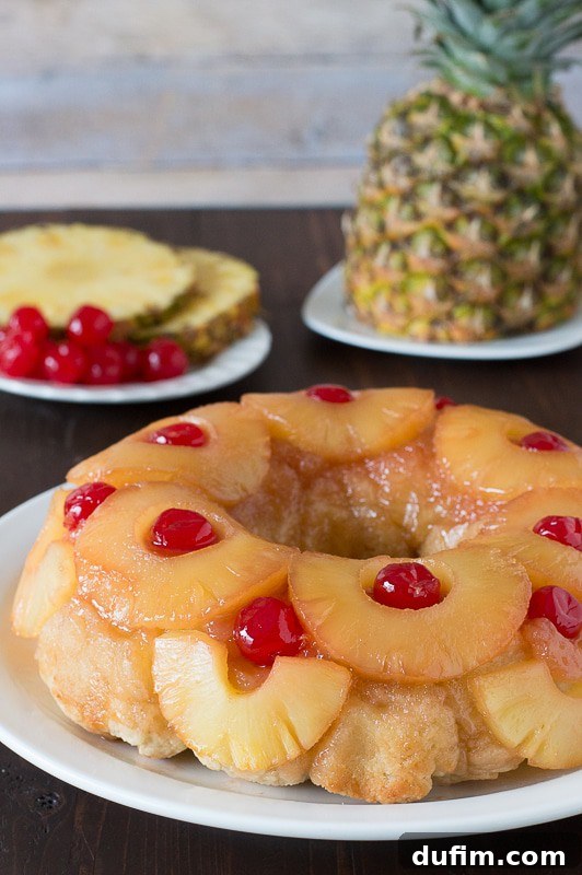 Pineapple Upside Down Monkey Bread with caramelized pineapple slices and cherries.