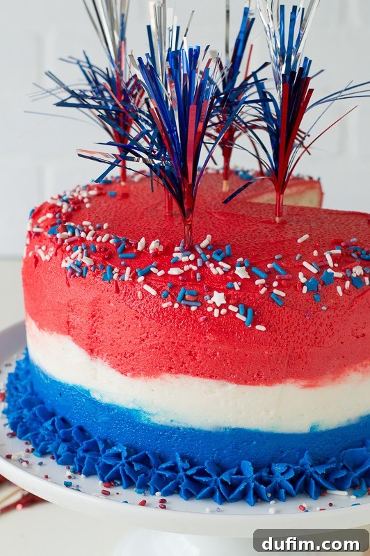 Stacked layers of the 4th of July Ombre Cake before final frosting, showing the vibrant red, white, and blue hues.