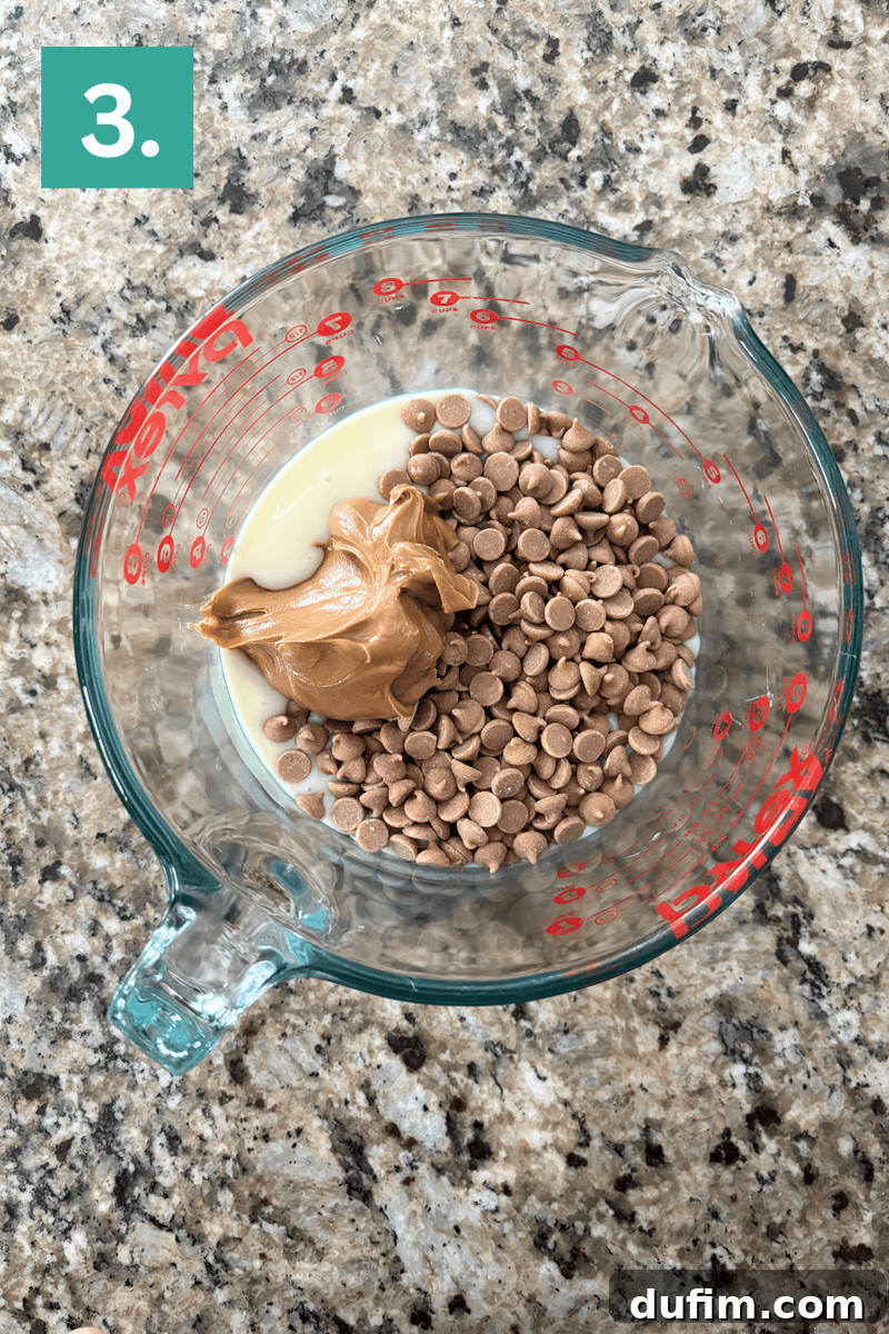 Decadent Chocolate Peanut Butter Fudge 8 A glass measuring cup filled with peanut butter, chocolate chips, and sweetened condensed milk sits on a granite countertop. A green square labeled 3. appears in the top left corner.