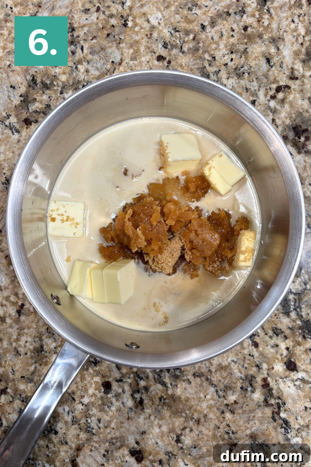 A saucepan on a granite countertop contains milk, cubed butter, and brown sugar. A green box with the number 6 is in the top left corner of the image.