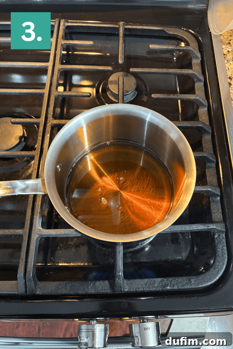 A stainless steel saucepan with caramel-colored liquid is heating on a gas stove. A green box with the number 3 is in the top left corner of the image.