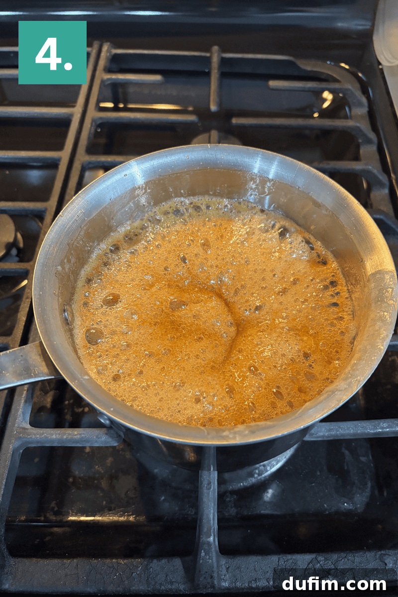 A saucepan filled with bubbling caramel sits on a stove burner. In the top left corner, a green box with the number 4 marks the step in a recipe.