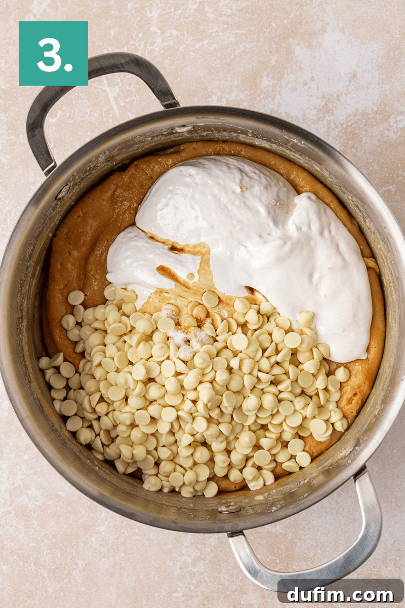 Guaranteed Perfect Vanilla Fudge 6 A saucepan filled with cookie dough mixture, topped with white chocolate chips and a dollop of marshmallow cream. A green box with the number 3 appears in the top left corner.