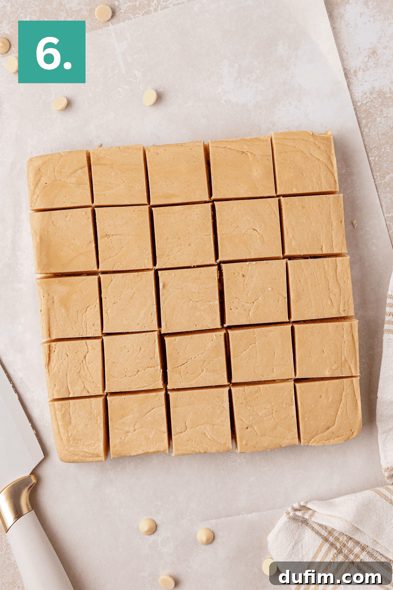Guaranteed Perfect Vanilla Fudge 9 A square block of light brown fudge cut into 25 even pieces sits on parchment paper. A knife with a white handle and a beige-striped cloth are beside it. A green square with the number 6 is in the top left corner.