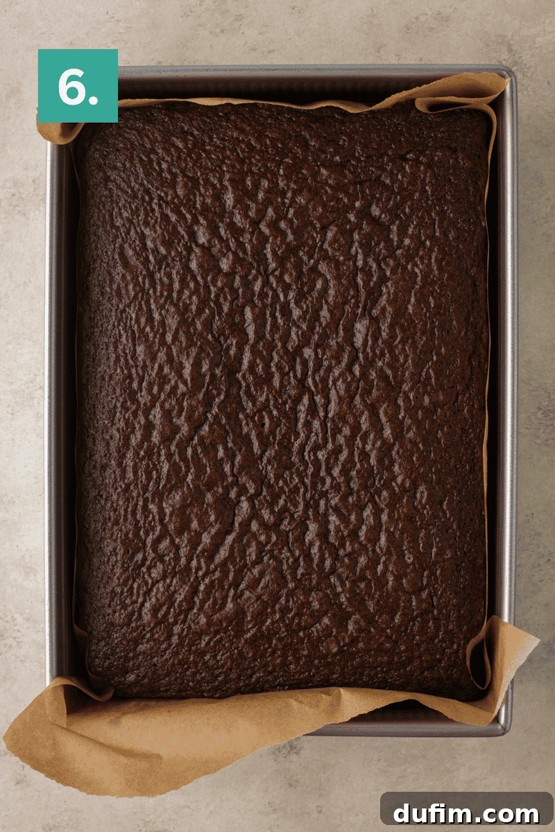Decadent Homemade 9x13 Chocolate Cake 11 The fully baked 9x13 chocolate sheet cake, fresh out of the oven and cooling in the pan.