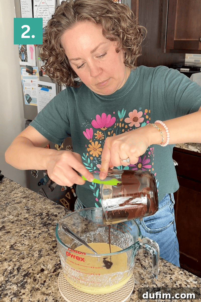 Decadent Homemade 9x13 Chocolate Cake 7 Step two of combining wet ingredients: pouring melted bittersweet chocolate into the egg mixture.
