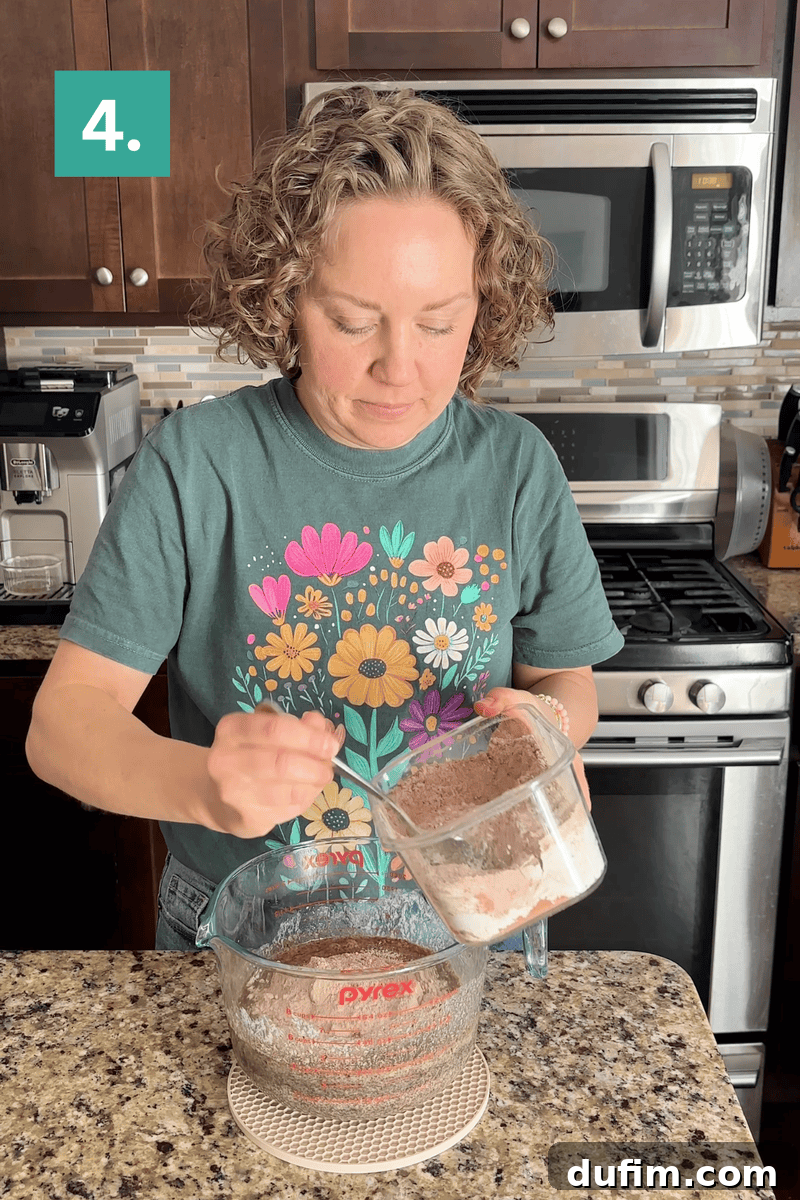 Decadent Homemade 9x13 Chocolate Cake 9 Step four of mixing the batter: Whisking the wet and dry ingredients together until just combined.