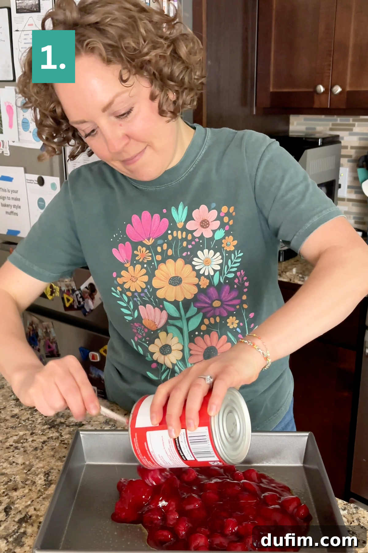 A person pours canned cherry filling into a baking pan, starting the first step of the recipe.