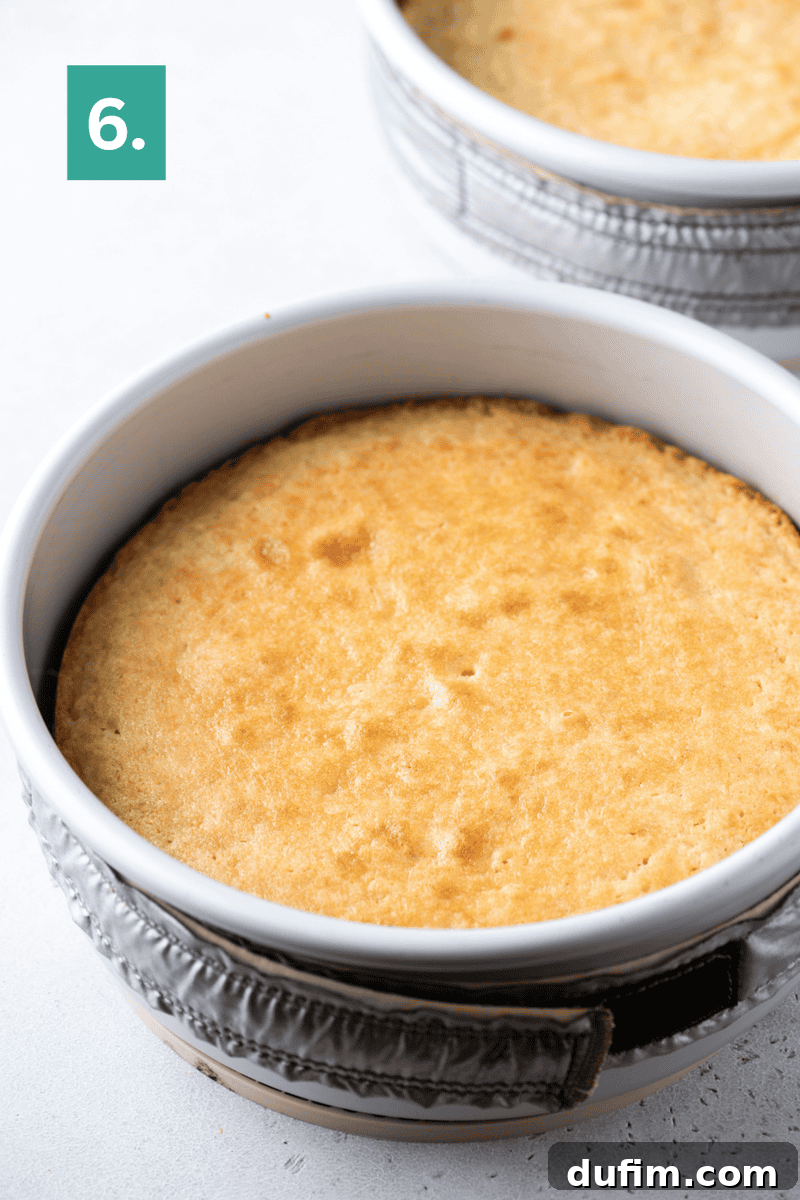 Homemade Coconut Cake That Tastes Like Real Coconut 8 Baked cake in a round white pan with a golden top.