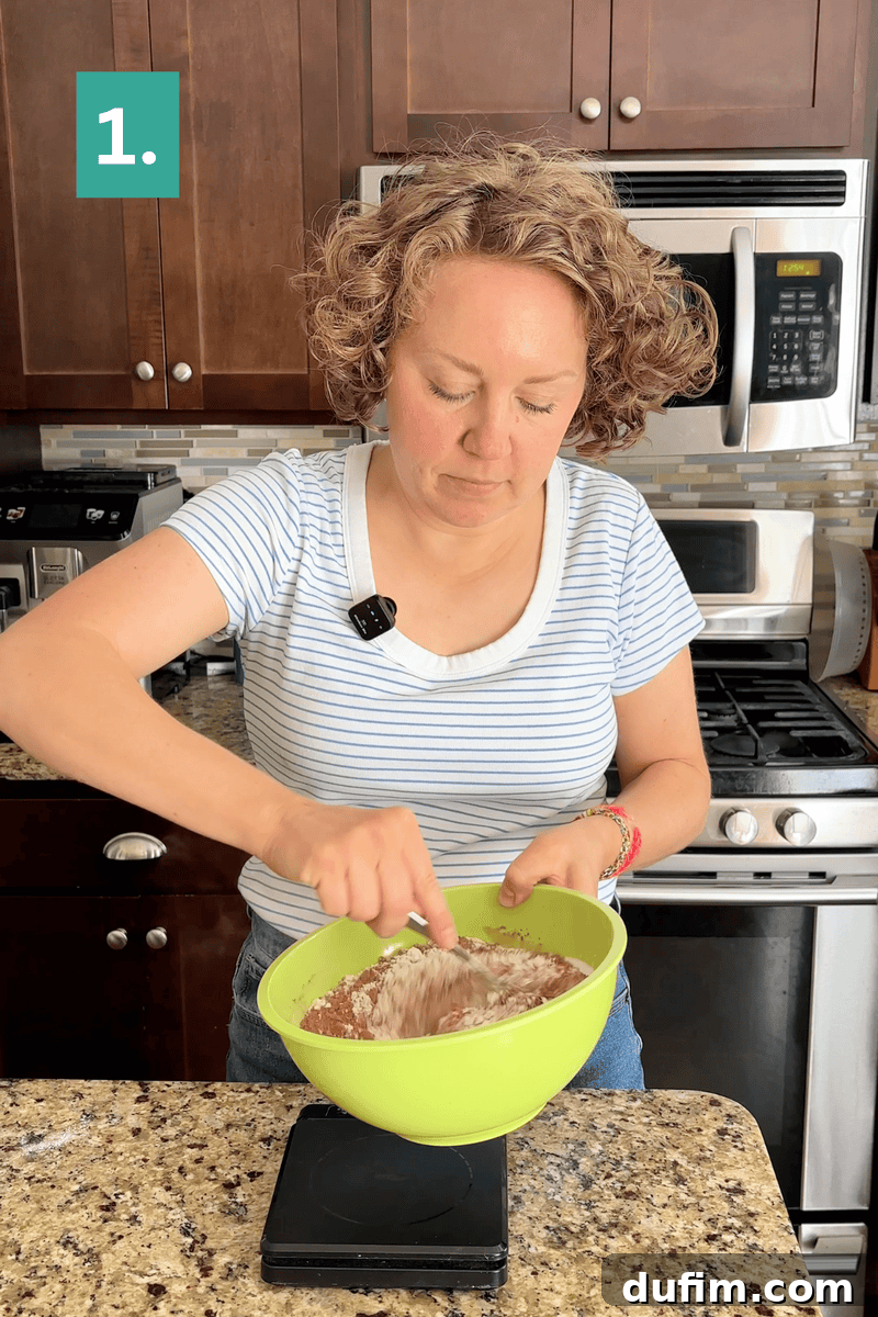 Decadent Mocha Cake Recipe for Coffee Lovers 7 A woman in a striped shirt mixes ingredients in a green bowl in a kitchen, standing at a counter near a stove. The image is labeled “1.” in the top left corner.